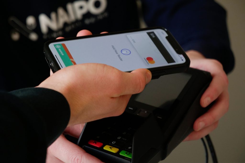 Person paying with credit card reader